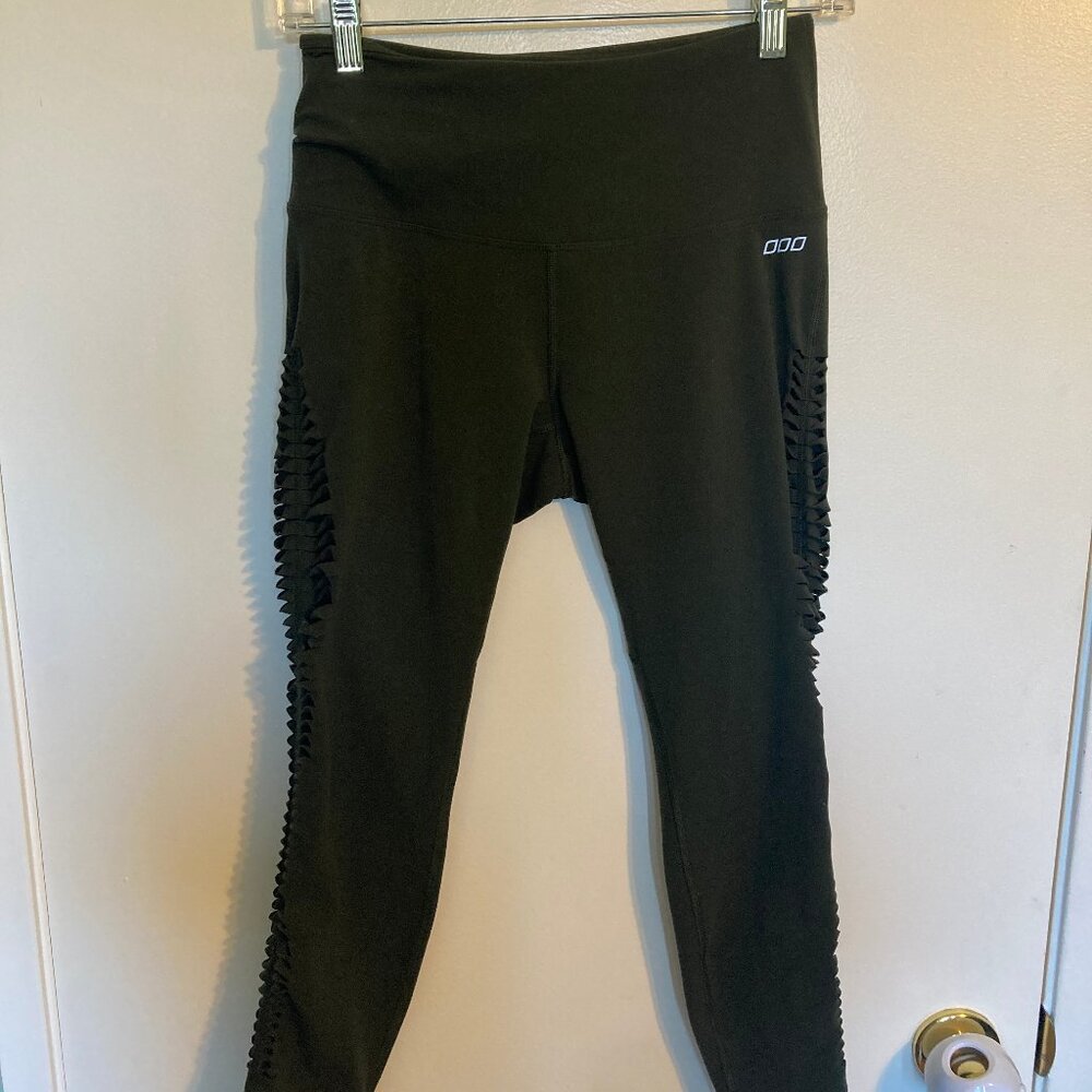 Lorna Jane army green capri leggings with side cutouts in size medium
